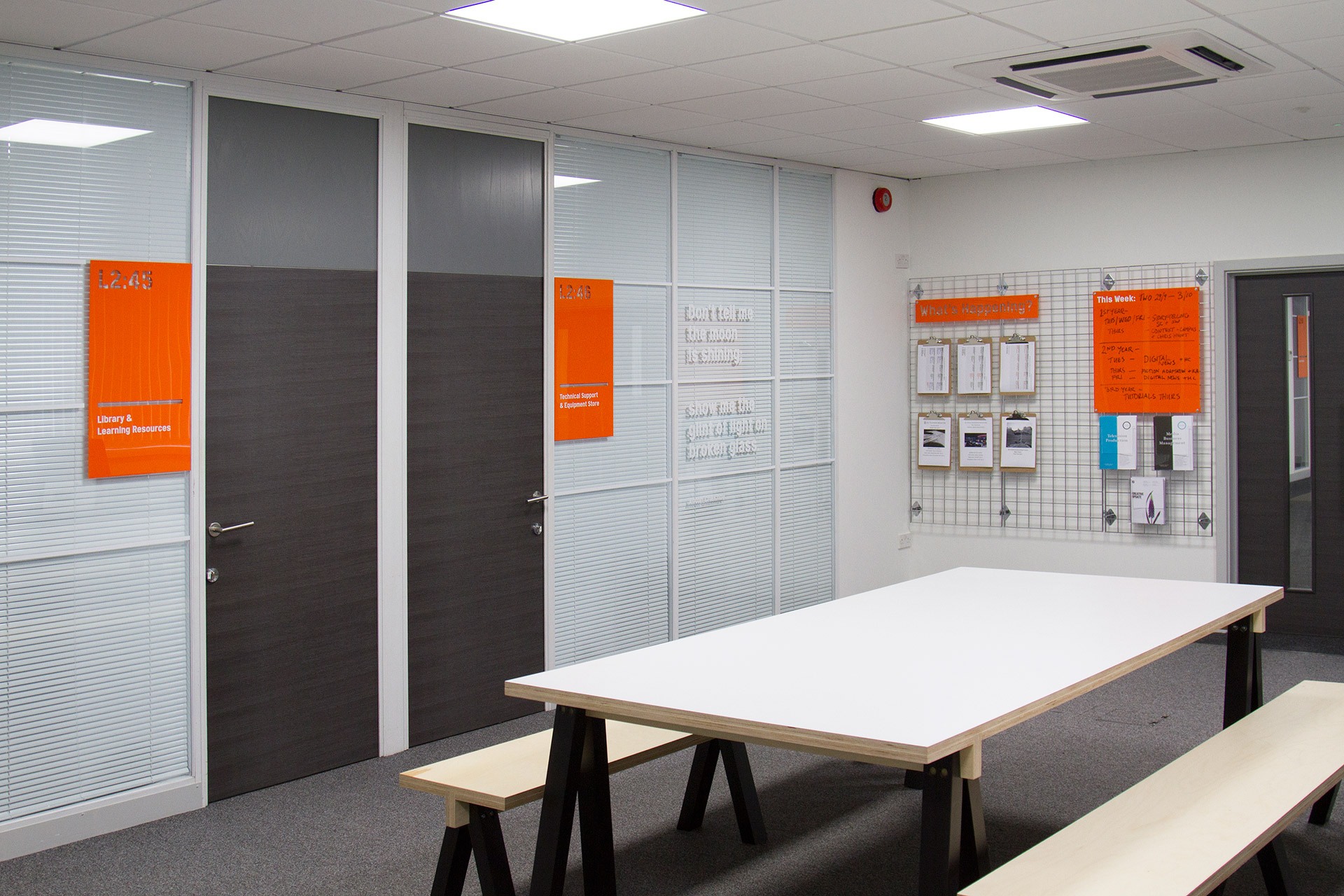 UCA Maidstone's studio space with orange acrylic room identifiers